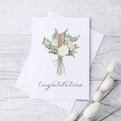 Congratulations Card Staged Congratulations card staged on white distressed wood background. Card features watercolor bouquet with "congratulations" written in calligraphy