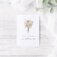 "No rain, no flowers" greeting card staged on distressed wood background with eucalyptus and tulle.
