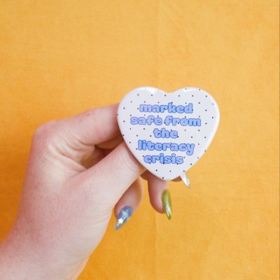 Marked Safe From the Literacy Crisis Heart Pin